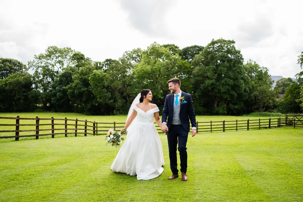 Bride and groom go for a walk at The Out Barn